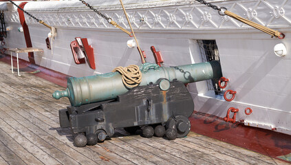 History, ship and cannon on deck for travel, sightseeing and landmark vessel in Denmark. Sailboat,...