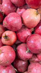  Garnets Closeup, Background .Lots of ripe red pomegranates on a market counter for sale and preparation of freshly squeezed juice.top view. Organic, natural, tasty and juicy. 