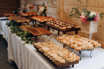 A variety of swirled pastries with golden skewers, decorated with fresh herbs.