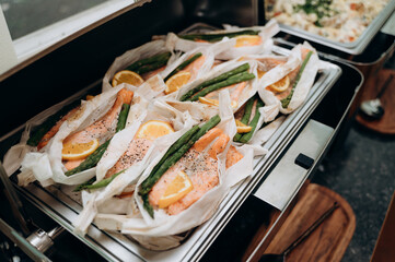 Baked fish with asparagus and citrus for flavor and seasoned with pepper.