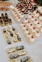 A wedding dessert table with a variety of gourmet pastries and cakes.