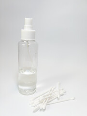 transparent container and cotton buds on a white background