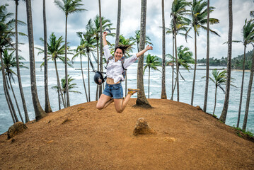 Happy jumping woman on Coconut Tree Hill on Sri Lanka © Volodymyr Shevchuk