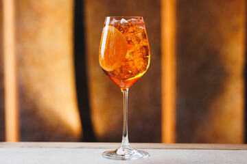 Cocktail Aperol Spritz on a light warm background. Bar, party, day off, holiday.