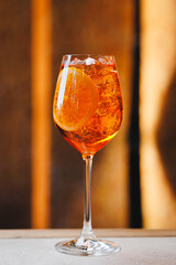 Cocktail Aperol Spritz on a light warm background. Bar, party, day off, holiday.