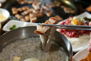 Korean food. cold buckwheat noodles with pork belly bbq
