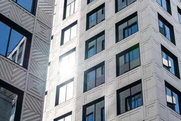 Modern Urban Architecture Showcased Among Tall Buildings Beneath a Blue Sky