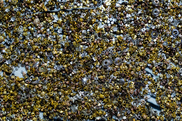 Closeup of multicolored beads scattered on a textured surface