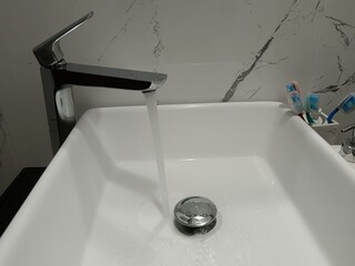 bathroom sink, open tap of water, 