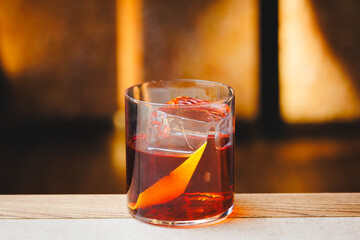 Negroni cocktail on a light warm background. Bar, party, day off, holiday.