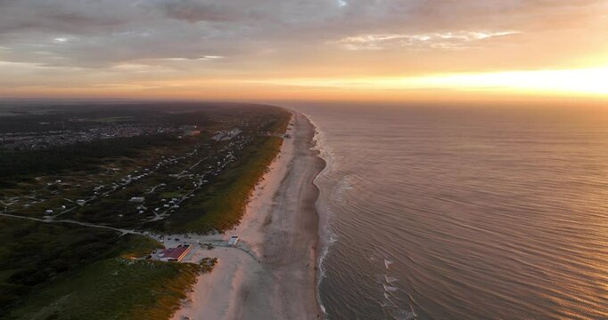 sunset at Texel beach, Wadden island in The Netherlands, golden hour, sunset, sunset beach walk. Aerial drone video.