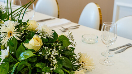 Beautiful flowers decorated on the table. Tables set for an event party or wedding reception. luxury elegant table setting dinner in a restaurant.