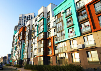 Obraz premium New modern residential architecture. Exterior Of residential building in residential area. New Condominium complex in Ecological district. Modern facade of a residential apartments building.