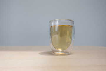 A glass of green tea in a transparent glass.