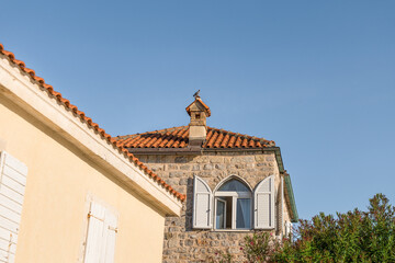 Pigeon on the chimney of a medieval stone house