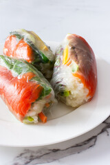 Savor the authentic taste of Vietnamese spring rolls with rice paper, fresh vegetables, salmon, and fish sauce, blending the best of Asian and Thai cuisine in a healthy, refreshing meal