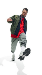 Male model in streetwear with athletic stance, wearing green bomber jacket, red hoodie, and grey...