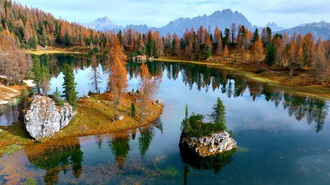 Scenic Lago di Federa in the Dolomites in Italy, autumn in the Dolomites, mirror reflection in the alpine lake in autumn, fall colours in the Dolomites