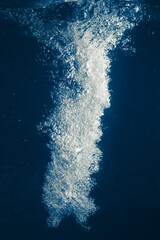 underwater splash bubbles in blue water environment
