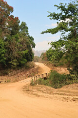 A windy dirt road leading to the village Ban Natane on the other side of Kong Lor Cave, a tourist attraction on the Thakhek Motorbike Loop, Laos