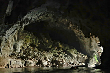 A boat on the river that runs through Kong Lor Cave, a tourist attraction along the Thakhek...
