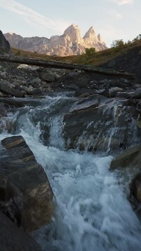 Aiguilles d Arves with iconic mountain peak and stream flowing in French Alps at France