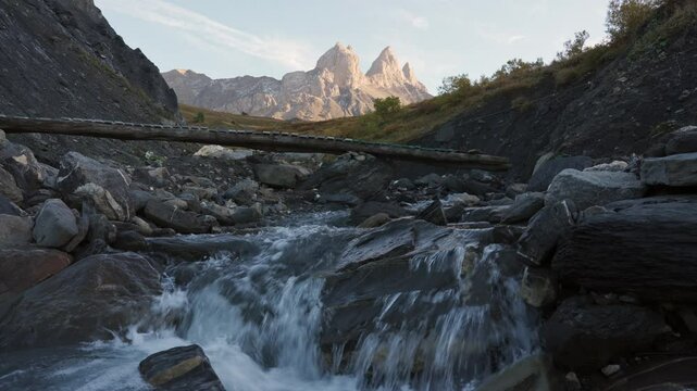 Aiguilles d Arves with iconic mountain peak and stream flowing in French Alps at France
