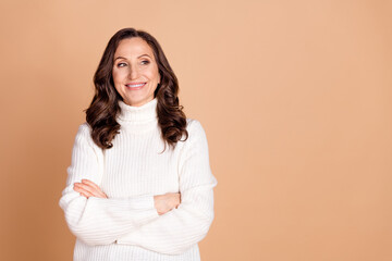 Fototapeta premium Photo of charming lovely senior woman crossed arms wear white trendy clothes empty space isolated on beige color background