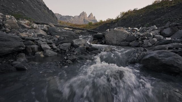 Aiguilles d Arves with iconic mountain peak and stream flowing in French Alps at France