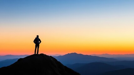 Fototapeta premium Person standing on a mountaintop at dawn, ready to face new challenges