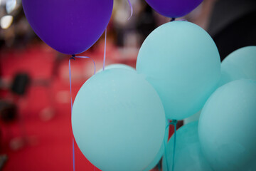blue and purple balloon on blurred background indoors, close up.