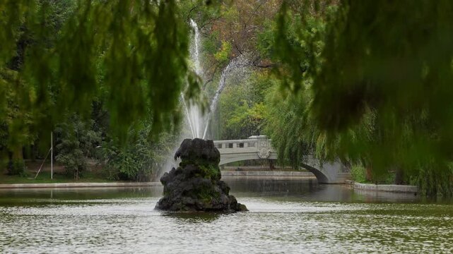 Cismigiu Park. 4K video with the water fountain from Cismigiu gardens park in Bucharest. Autumn landscape in thie beautiful historical park in Romania.