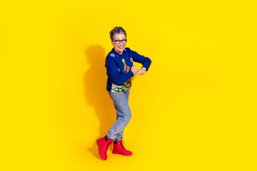 Photo of adorable cheerful pensioner wear blue stylish clothes have fun isolated on yellow color background
