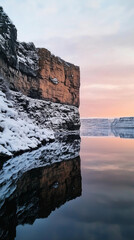 Fjord with snow-covered cliffs and tranquil waters