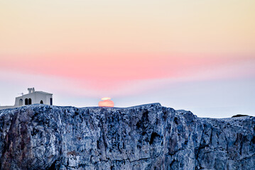 Beautiful sunset with orange sky on the beach of Menorca, Balearic Islands. Sunset, nature