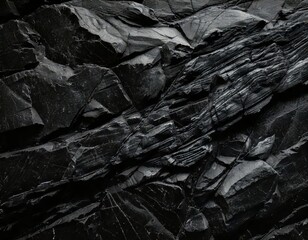 Dark Stone Texture: Abstract background image of rough, fragmented black stones, ideal for design projects needing a strong, dramatic, and textured aesthetic. 