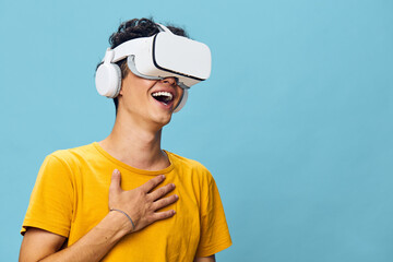 Virtual reality experience, happy young man wearing VR headset, blue background, engaging moment, technology excitement, immersive entertainment, digital adventure, innovation, joyful interaction