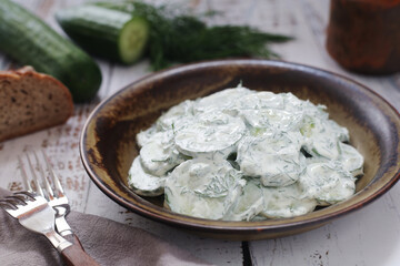 A traditional Polish salad Mizeria in rustic style
