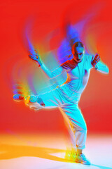 Creative design. Dynamic energetic dance, young woman in white dancing hip hop, freestyle on bright red background with colorful neon motion blur effect. Concept of dance, art, modern style, youth