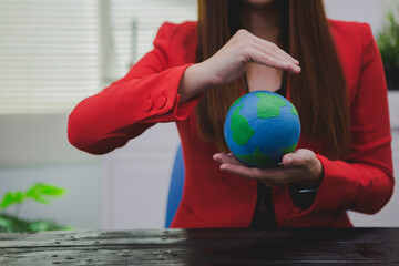 An Asian woman in a bright red shirt passionately advocates for the environment. Her commitment to...