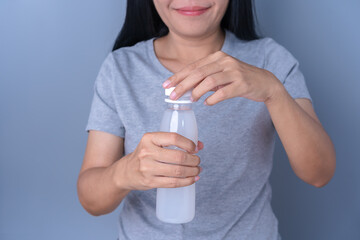 Close-up of a woman's hand holding a plastic bottle and opening a plastic bottle. Ideas about drinking water each day and a healthy lifestyle in daily life plastic recycling concept.