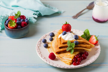 Crepes, thin pancakes  with yogurt and berries. Healthy food for breakfast