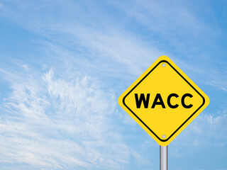 Yellow transportation sign with word WACC (abbreviation of Weighted average cost of capital) on blue color sky background