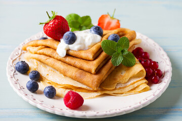 Crepes, thin pancakes  with yogurt and berries. Healthy food for breakfast