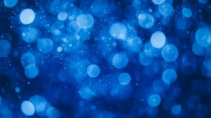 Soft blue bokeh lights creating dreamy background, perfect for holidays.