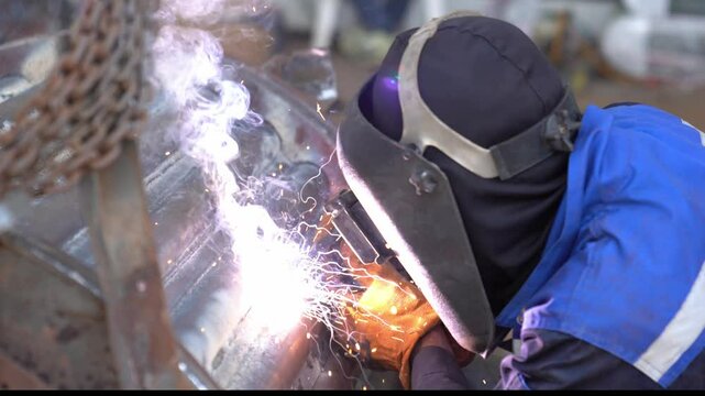 Welder welding boiler tube in an industry