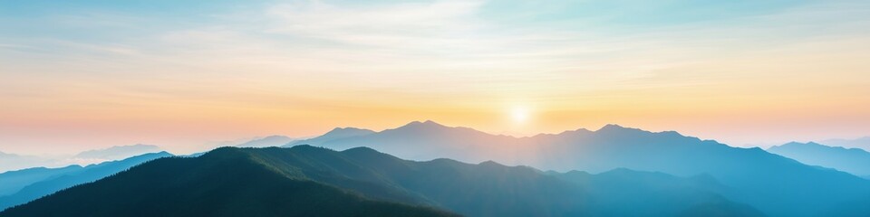 Obraz premium The mountains are covered in trees and the sky is a beautiful shade of blue. The sun is setting, casting a warm glow over the landscape
