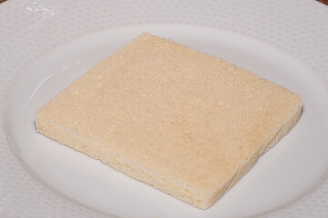 Closeup slice of white sandwich bread on a plate