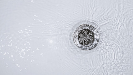 Slow water drain. Household plumbing problem. Water draining down slowly in tub. Bath cleaning.