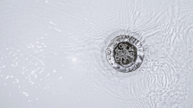 Slow water drain. Household plumbing problem. Water draining down slowly in tub. Bath cleaning.